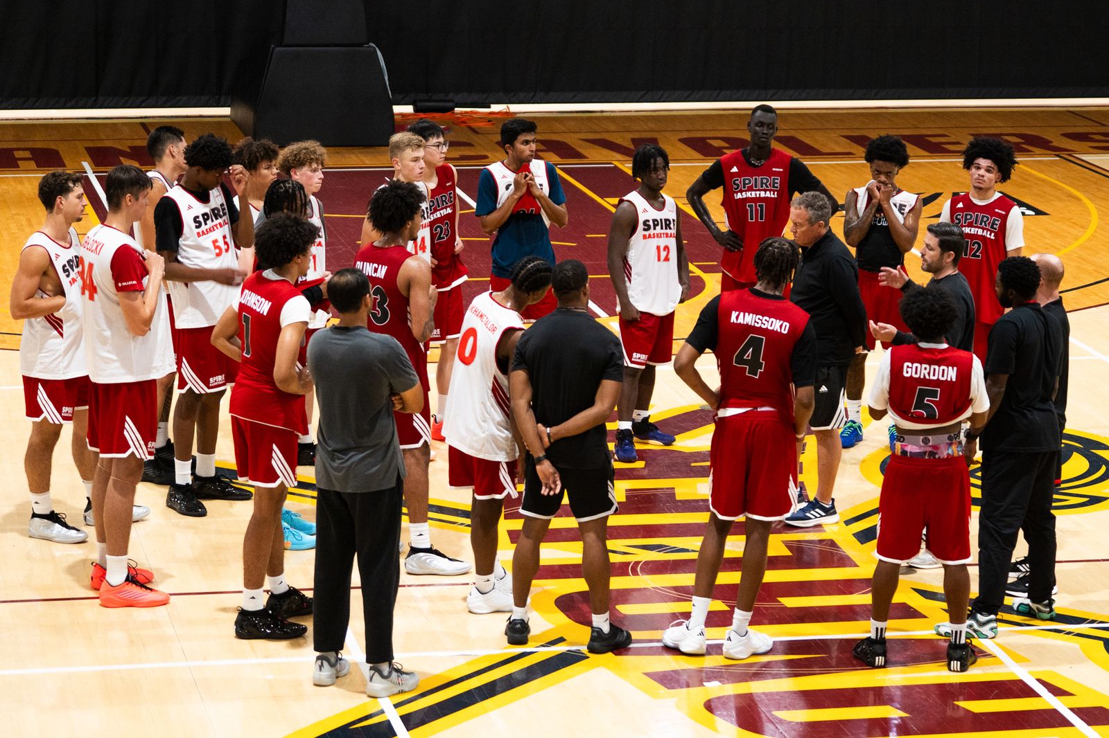 SPIRE men's basketball huddle on the practice floor